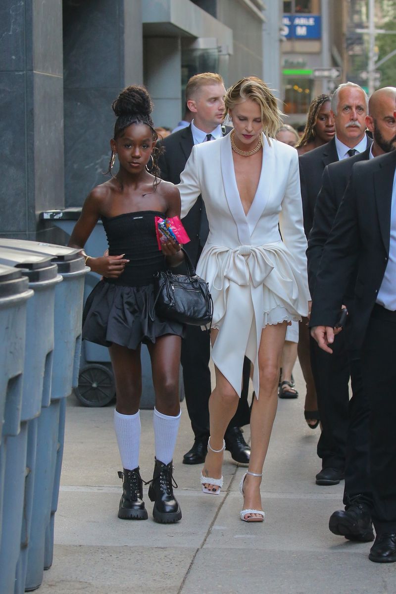 The Oscar-winning actress wore a custom white Dior blazer-inspired mini dress designed under the creative direction of Jonathan Anderson, featuring a plunging neckline and a dramatic draped waist detail, paired with silver strappy heels and a gold choker necklace.
