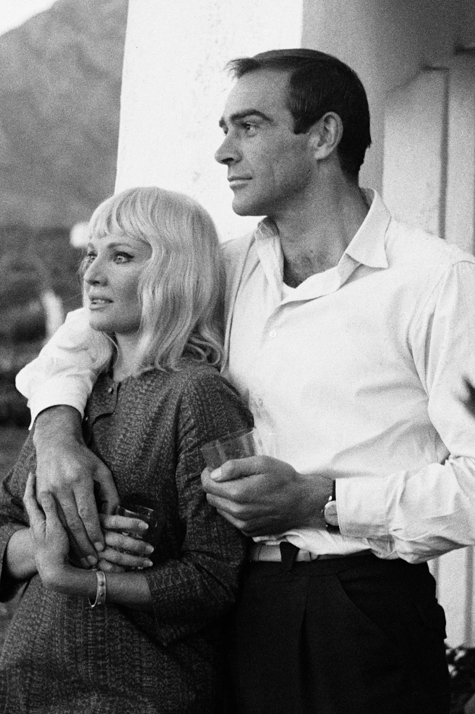 Sean Connery posing with his arm around his wife, actress Diane Cilento while on honeymoon