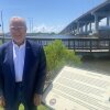 Mayor Jay Willis stands next to a historical marker for a UFO sighting in Pascagoula, Miss.